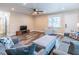 Open-concept living area with modern flooring, comfortable gray seating, and seamless flow to other rooms, perfect for relaxation at 7065 73Rd N St, Pinellas Park, FL 33781