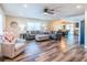 Bright and airy living room featuring wood floors, plush seating, and a ceiling fan at 7065 73Rd N St, Pinellas Park, FL 33781