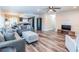 Well-lit living room featuring stylish flooring, a cozy seating arrangement, and a seamless transition to the kitchen and dining spaces at 7065 73Rd N St, Pinellas Park, FL 33781