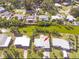 Aerial view of a property with lush greenery, a waterfront and a well-maintained lawn at 7313 Royal Palm Dr, New Port Richey, FL 34652