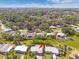 Aerial view of a property surrounded by lush greenery and waterfront scenery at 7313 Royal Palm Dr, New Port Richey, FL 34652