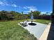 Relaxing backyard with a table, umbrella, lounge chair, and a beautiful canal view at 7313 Royal Palm Dr, New Port Richey, FL 34652