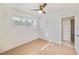Cozy bedroom featuring tile floors, a ceiling fan, and a bright window at 7313 Royal Palm Dr, New Port Richey, FL 34652