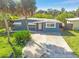 Charming single-story home with well-maintained landscaping and a quaint front entrance at 7313 Royal Palm Dr, New Port Richey, FL 34652
