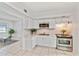 Bright kitchen featuring white cabinetry, stainless steel appliances, and a tile backsplash at 7313 Royal Palm Dr, New Port Richey, FL 34652