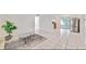 Open-concept living room with tile flooring, ample space, and a seamless transition to the kitchen at 7313 Royal Palm Dr, New Port Richey, FL 34652