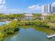 Aerial view capturing the building, surrounding foliage, and waterfront with a dock at 741 Mainsail Dr, Tampa, FL 33602