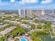 Scenic aerial of residential condos with a shared pool and lush greenery, near commercial areas and waterway at 741 Mainsail Dr, Tampa, FL 33602