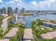 Stunning aerial view of waterfront condos with gorgeous city skyline backdrop, lush landscaping, and boat docks at 741 Mainsail Dr, Tampa, FL 33602