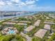 Aerial shot of residential community with manicured landscaping, a pool, and waterway views at 741 Mainsail Dr, Tampa, FL 33602