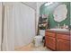 Well-lit bathroom with modern fixtures, ladder shelving, and a decorative shower curtain at 741 Mainsail Dr, Tampa, FL 33602