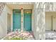 A beautiful building entrance with teal doors and brick walkway at 741 Mainsail Dr, Tampa, FL 33602
