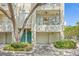 Exterior view of a multi-story home with a private balcony and garage entrance and green landscaping at 741 Mainsail Dr, Tampa, FL 33602