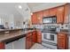 Well-equipped kitchen with stainless steel appliances, ample counter space, and warm wood cabinetry at 741 Mainsail Dr, Tampa, FL 33602