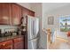 Kitchen featuring stainless steel appliances, wood cabinets, and an adjacent staircase, brightened by a window at 741 Mainsail Dr, Tampa, FL 33602