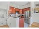 Charming kitchen featuring warm wood cabinets, stainless steel appliances, and a cozy breakfast bar area at 741 Mainsail Dr, Tampa, FL 33602
