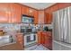 Bright kitchen with stainless steel appliances, wood cabinets, and designer floors at 741 Mainsail Dr, Tampa, FL 33602