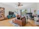 Bright living room with hardwood floors, stylish furnishings, and sliding glass door to balcony at 741 Mainsail Dr, Tampa, FL 33602