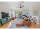 Comfortable living room with hardwood floors, a ceiling fan, and a sliding glass door to a private balcony at 741 Mainsail Dr, Tampa, FL 33602