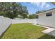 A spacious backyard features lush green grass and a pristine white fence at 791 44Th N Ave, St Petersburg, FL 33703