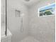 Bright bathroom with an elegant glass shower, modern fixtures, and neutral tiles at 791 44Th N Ave, St Petersburg, FL 33703