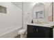 Modern bathroom features a shower-tub combo with stylish vanity and decorative mirror at 791 44Th N Ave, St Petersburg, FL 33703