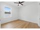 A bright bedroom features a ceiling fan, light wood flooring, and a window at 791 44Th N Ave, St Petersburg, FL 33703