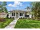 Charming home featuring a well-manicured lawn, fresh landscaping, and a welcoming walkway to the front door at 791 44Th N Ave, St Petersburg, FL 33703