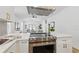 A chef's kitchen with stainless appliances, white cabinetry, island and pendant lighting at 791 44Th N Ave, St Petersburg, FL 33703