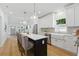 The kitchen features bar seating, stainless steel appliances, and white cabinetry at 791 44Th N Ave, St Petersburg, FL 33703