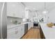 A chef's kitchen with stainless appliances, white cabinetry, island and pendant lighting at 791 44Th N Ave, St Petersburg, FL 33703