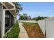 Landscaped backyard with a well-maintained lawn and view of the neighborhood from the screened lanai at 8060 Timberlake Ave, Spring Hill, FL 34606
