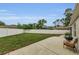 Spacious backyard with a well-maintained lawn, privacy fence, and patio with grill at 8060 Timberlake Ave, Spring Hill, FL 34606
