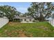Spacious backyard with a patio, enclosed lanai, and well-maintained lawn offers a relaxing outdoor space at 8060 Timberlake Ave, Spring Hill, FL 34606