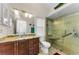 Updated bathroom features a glass enclosed shower and a granite vanity at 8060 Timberlake Ave, Spring Hill, FL 34606