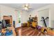 Multi-purpose bedroom featuring hardwood floors, a ceiling fan, and natural light at 8060 Timberlake Ave, Spring Hill, FL 34606