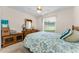 Comfortable bedroom with a ceiling fan, a large window, and classic wooden furniture at 8060 Timberlake Ave, Spring Hill, FL 34606