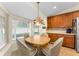 Sunny breakfast nook featuring a round wooden table and bright window views at 8060 Timberlake Ave, Spring Hill, FL 34606