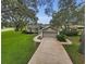 Charming front exterior with a well-maintained lawn and mature trees at 8060 Timberlake Ave, Spring Hill, FL 34606