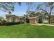 Home with arched windows and mature landscaping at 8060 Timberlake Ave, Spring Hill, FL 34606