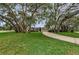 Well-maintained home with a large front yard and mature trees providing shade at 8060 Timberlake Ave, Spring Hill, FL 34606