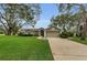 Charming single-story home with a well-manicured lawn and mature trees at 8060 Timberlake Ave, Spring Hill, FL 34606