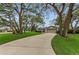 Home with mature trees and a well-manicured lawn at 8060 Timberlake Ave, Spring Hill, FL 34606
