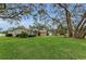 Home boasts a well-kept lawn, lovely landscaping, and mature trees, enhancing its curb appeal at 8060 Timberlake Ave, Spring Hill, FL 34606