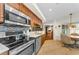 Kitchen with stainless steel appliances, tile flooring, and wood cabinetry at 8060 Timberlake Ave, Spring Hill, FL 34606