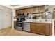 Spacious kitchen featuring stainless steel appliances and dark wood cabinets at 8060 Timberlake Ave, Spring Hill, FL 34606