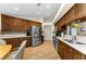 Well-lit kitchen with ample wood cabinets and modern stainless-steel appliances at 8060 Timberlake Ave, Spring Hill, FL 34606