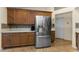 Kitchen showcasing stainless steel refrigerator, tile backsplash, and tiled flooring at 8060 Timberlake Ave, Spring Hill, FL 34606