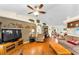 Spacious living room with vaulted ceilings, wood floors and a ceiling fan at 8060 Timberlake Ave, Spring Hill, FL 34606