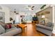 Cozy living room with warm wood floors, rocking chair, and unique wall decor at 8060 Timberlake Ave, Spring Hill, FL 34606